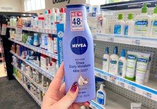 hand holding bottle of Nivea body lotion