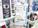 hand holding a shark cordless vacuum system in front of signage at target