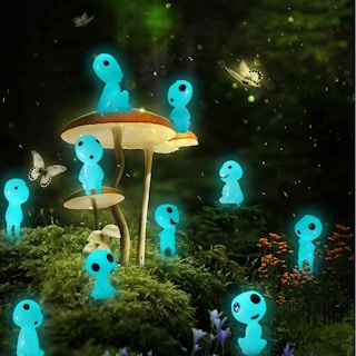 A set of glow-in-the-dark ghost tree elves placed in a garden.