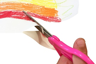 Scissors cutting colorful paper.