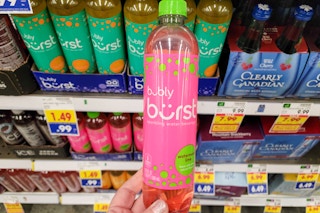 hand holding a bottle of bubly burst sparkling water at kroger