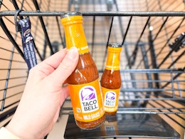 hand holding a bottle of taco bell sauce