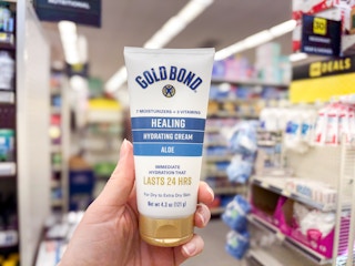hand holding gold bond lotion