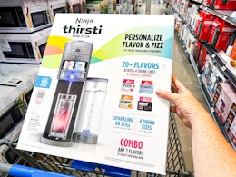hand holding box of ninja thirsti drink maker in walmart cart