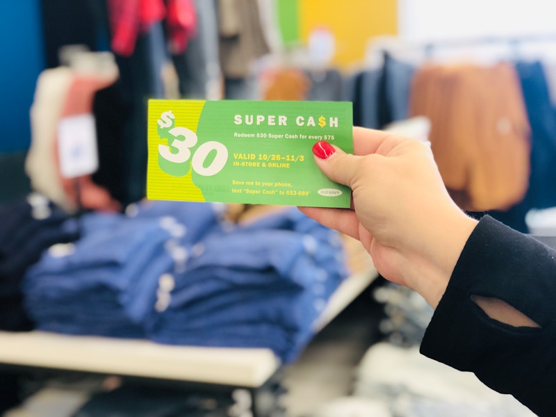 A person holding Old Navy super cash inside the store