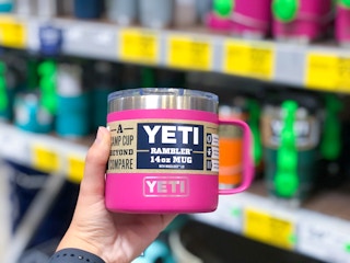 hand holding YETI mug in front of clearance display at Lowe's