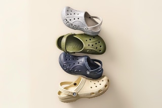 Lifestyle image of Crocs kids' clogs in various colors stacked vertically