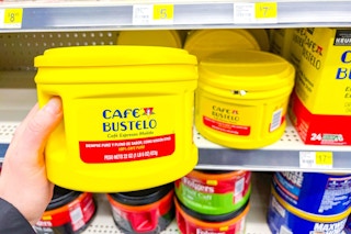 hand holding a tub of cafe bustelo coffee