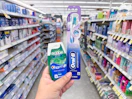 hand holding crest and oral-b products in walgreens