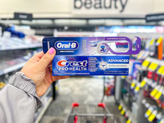 hand holding crest and oral-b products