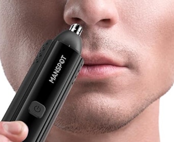 a person using a nose hair trimmer 
