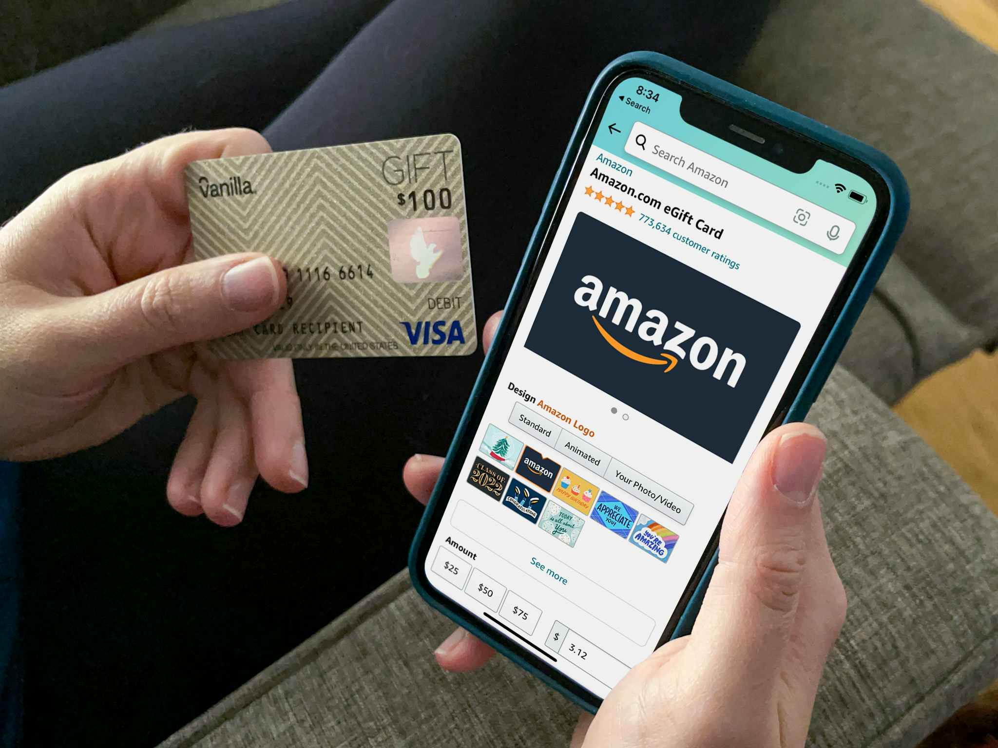 A person holding a visa gift card next to a cell phone open to an amazon gift card purchase page.