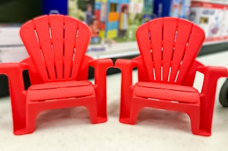 2 little tikes adirondack chairs sitting on the floor