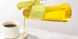 An olive oil dispenser pouring olive oil