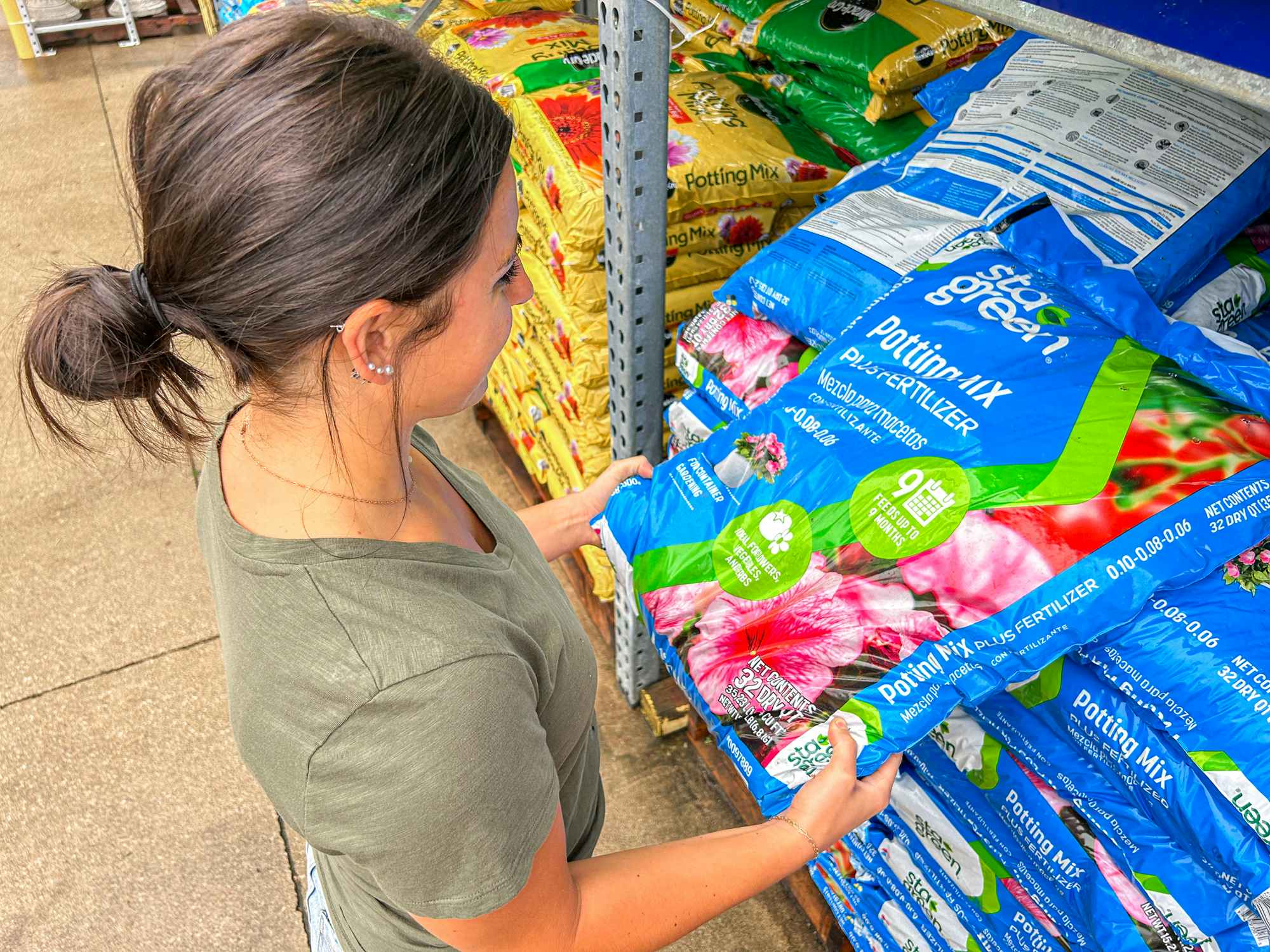 a person looking at fertilizer at lowes