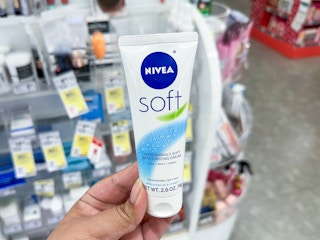hand holding nivea soft creme lotion at walgreens