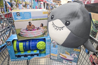 inflatable pool, float, and water toys in a cart
