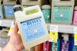hand holding mrs meyers hand soap refill