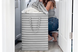woman taking clothes out of large laundry basket