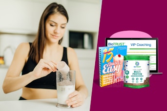 woman pouring a scoop of protein powder into her glass