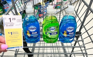 hand holding sales tag in front of three bottles of Dawn dish soap inside shopping cart