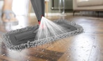 a spray mop spraying cleaner on hardwood floors