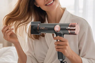 a woman using a blow dryer