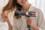 a woman using a blow dryer