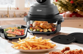 a glass air fryer on a table with plates of food