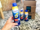 someone holding sunscreen next to amazon box