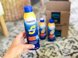 someone holding sunscreen next to amazon box