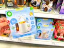 hand holding air wick diffuser starter kit in front of a target shelf