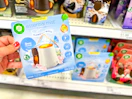 hand holding air wick diffuser starter kit in front of a target shelf