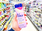 hand holding nair body cream in walgreens