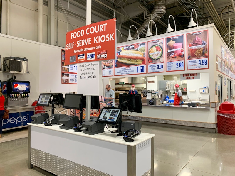 The food court with a sign stating there is a limited menu and no dinning-in.