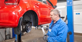 A mechanic repairing a car brake