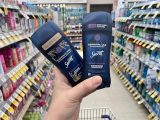 Two Secret essential oil deodorant held in hand in store.