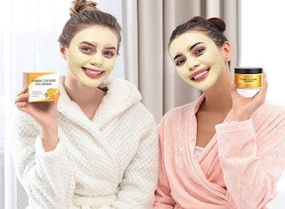 two women with clay face masks on