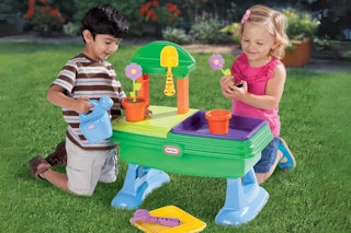 two kids playing with the Little Tikes Garden Table outside
