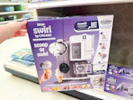 hand grabbing a ninja creami scoop & swirl maker off a target shelf