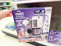hand grabbing a ninja creami scoop & swirl maker off a target shelf