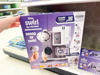 hand grabbing a ninja creami scoop & swirl maker off a target shelf