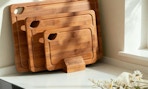3 bamboo cutting boards on a counter 