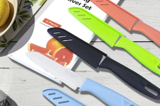 colorful knives on a light grey wooden surface