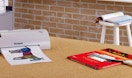 a thermal printer on a table with a pack of thermal pouches