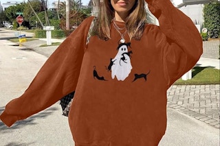 a woman wearing a halloween sweatshirt