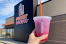 a hand holding up a dunkin donuts refresher