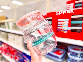 hand holding a pyrex 6-piece set in front of a target shelf