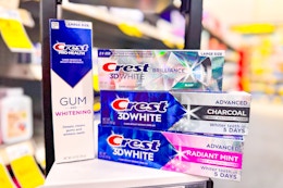 4 crest toothpastes including crest gum, brilliance, and 3d white on a shelf