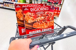 person pushing a cart with 2 digiorno pizzas in it